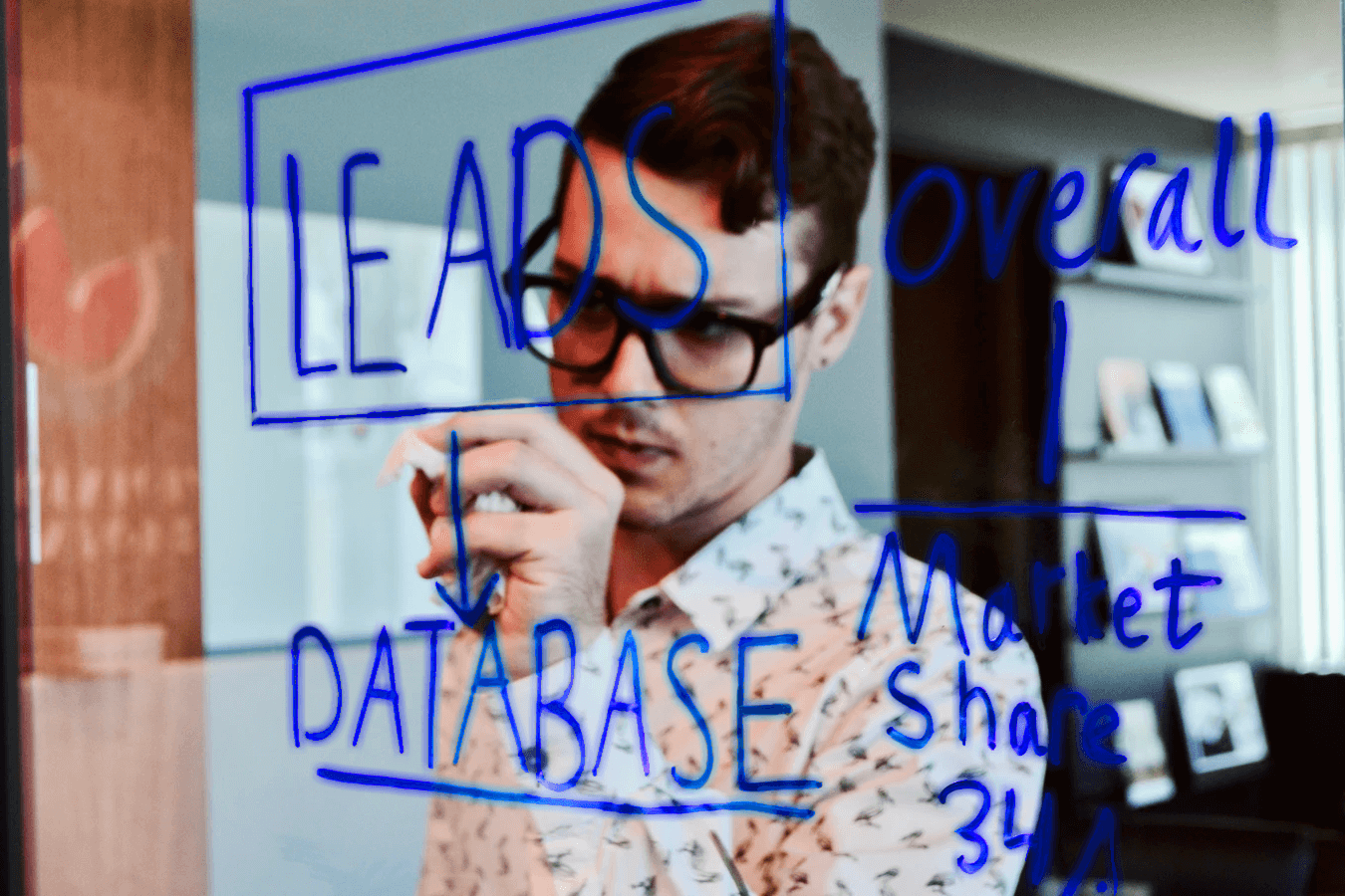 Professional drawing glowing business diagrams on a Lightboard while facing the audience