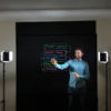 Presenter on lightboard with drawings