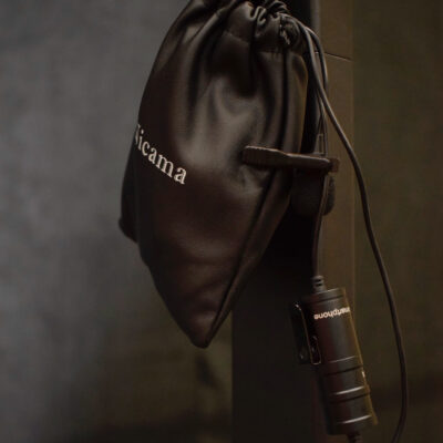 Clip on microphone in black inside the packaging