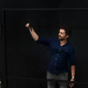 Person using the black squeegee on lightboard
