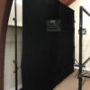 Standalone black backdrop fabric product side view with studio lights and lightboard